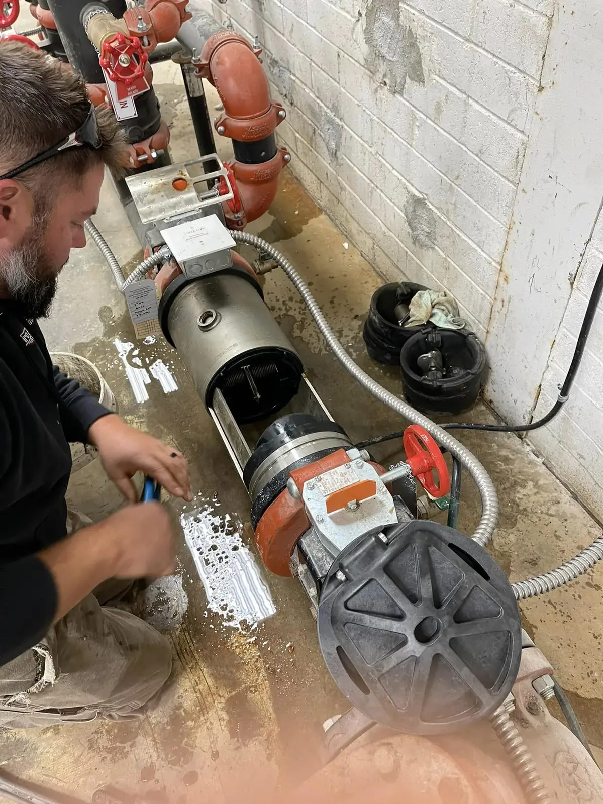 Fire Protection Solutions technician repairing a backflow preventer, Mentor, OH